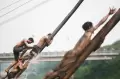 Keseruan Lomba Panjat Pinang di Banjir Kanal Timur